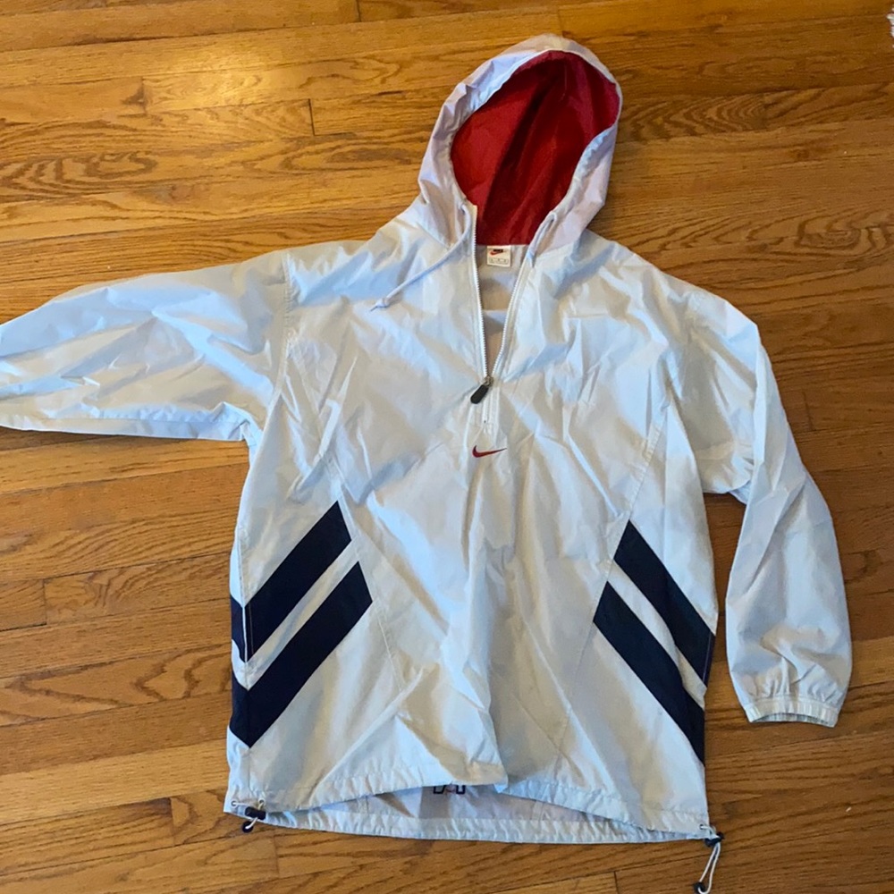 Tan Nike tan jacket with red hood and navy stripe